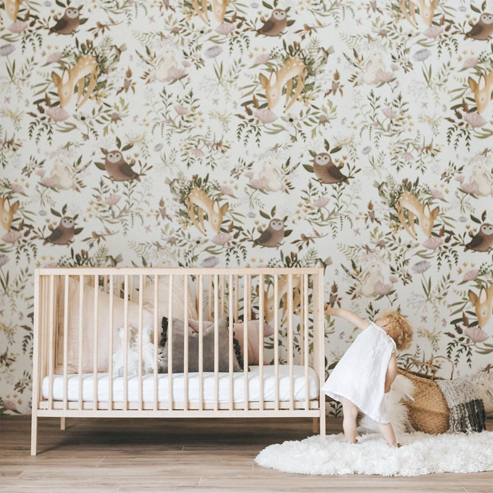 nursery with forest inspired wallpaper