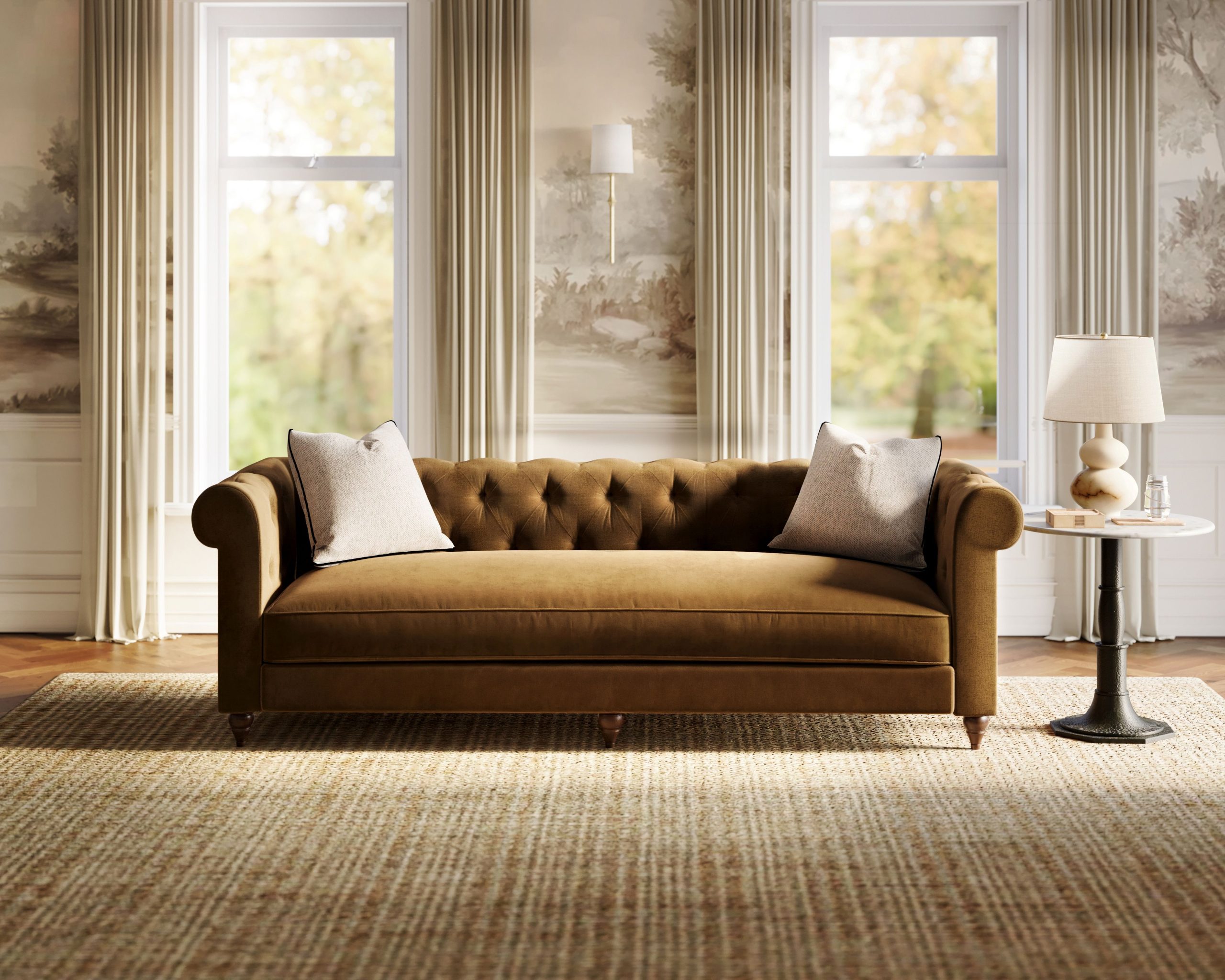 A traditional living room design features a natural jute rug, a brown velvet Chesterfield sofa, and a white marble and iron side table