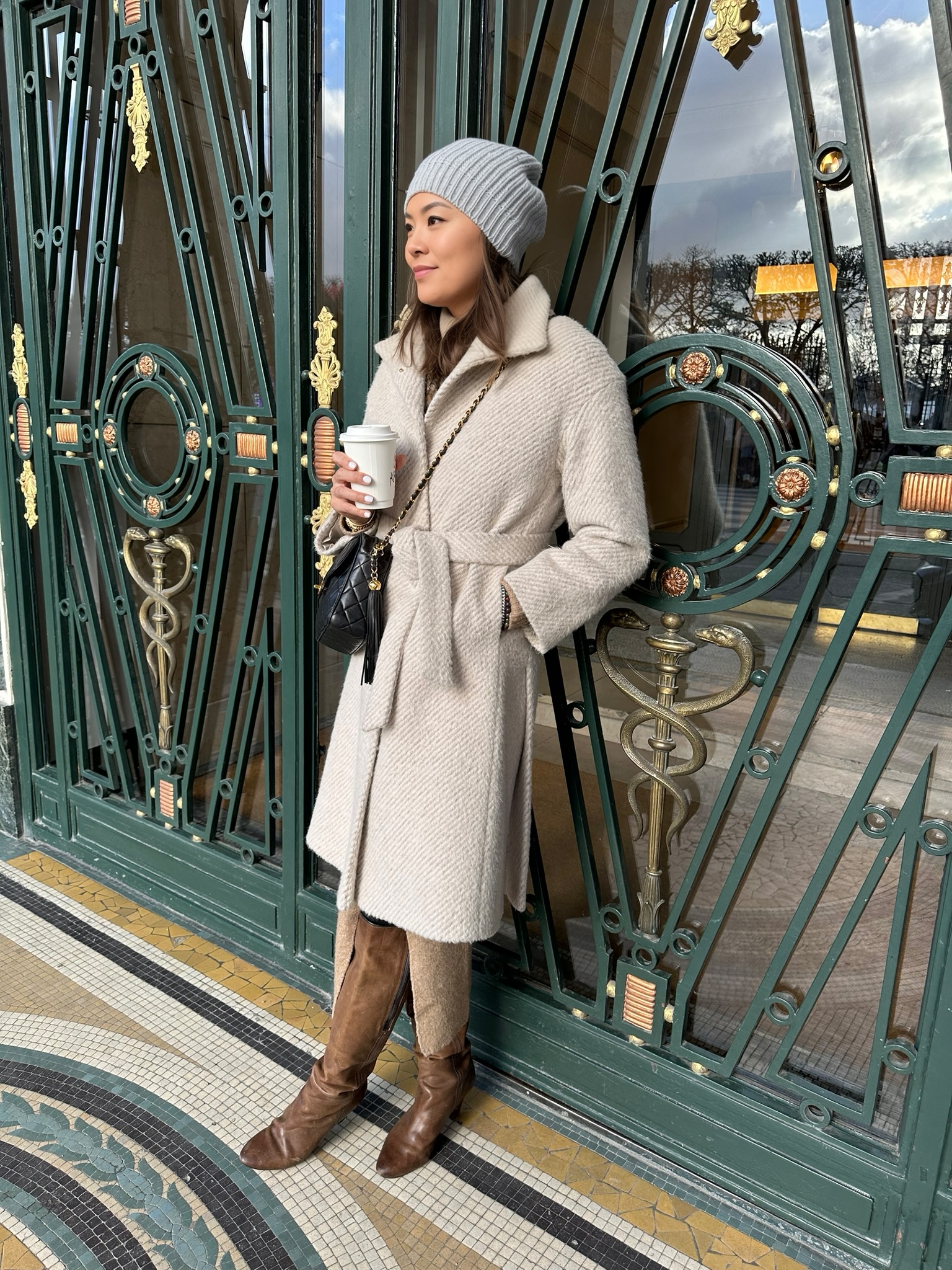 woman leaning against gate in paris