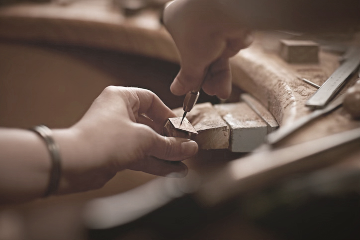 An artisan crafts handmade furniture