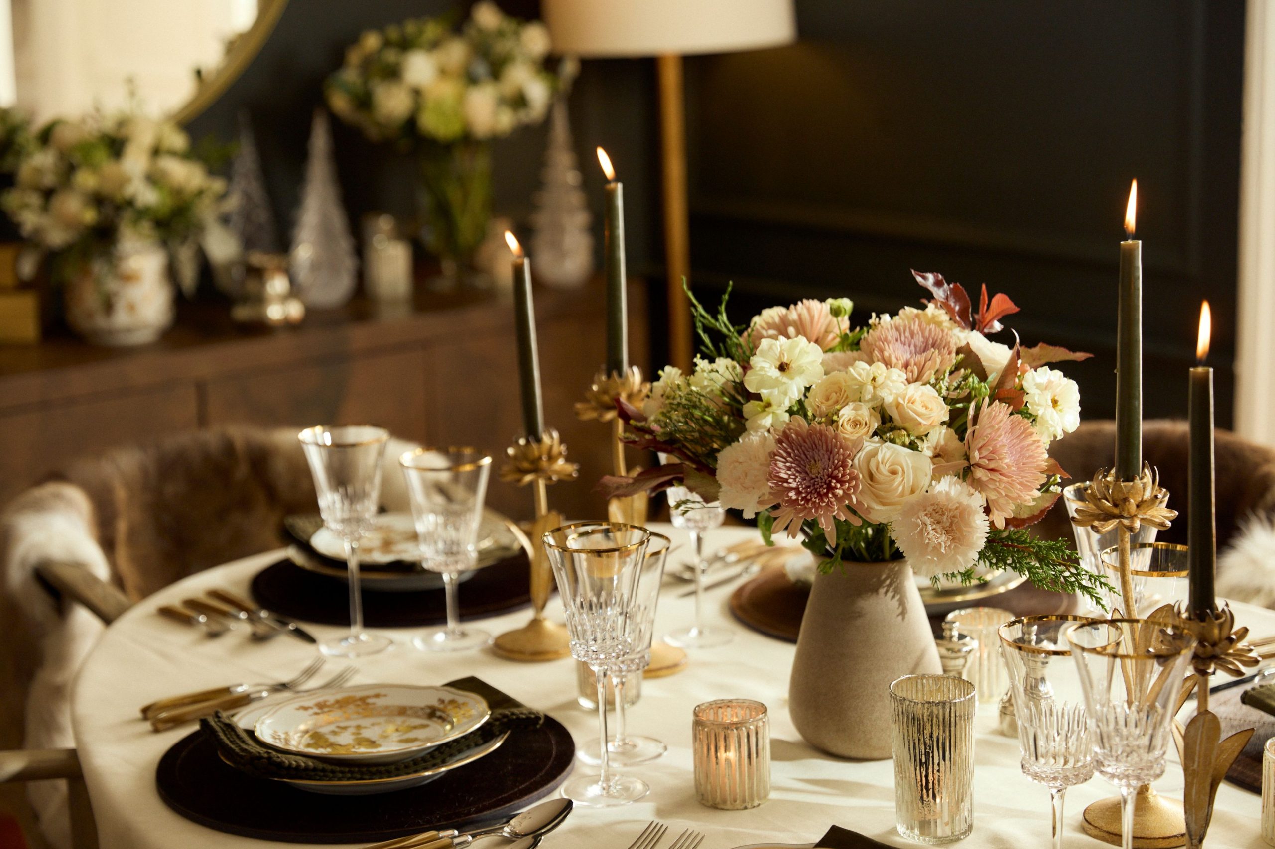 A Kathy Kuo Home x UrbanStems floral arrangement on an oval dining table in a New York City apartment