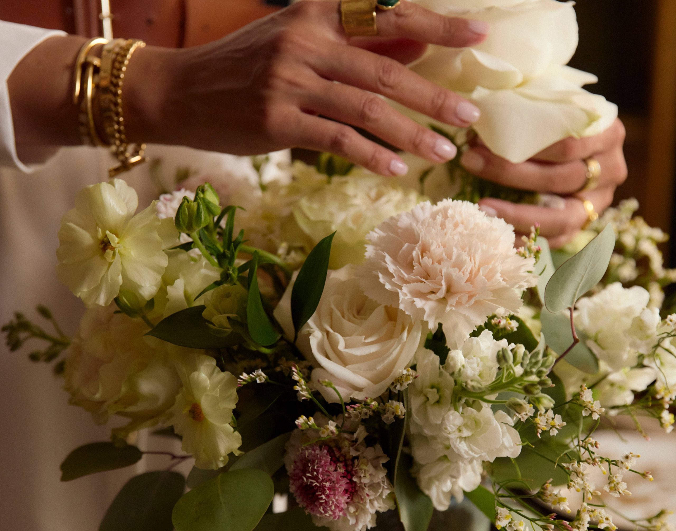 A Kathy Kuo Home x Urbanstems floral arrangement with garden roses, ranunculus, and carnations