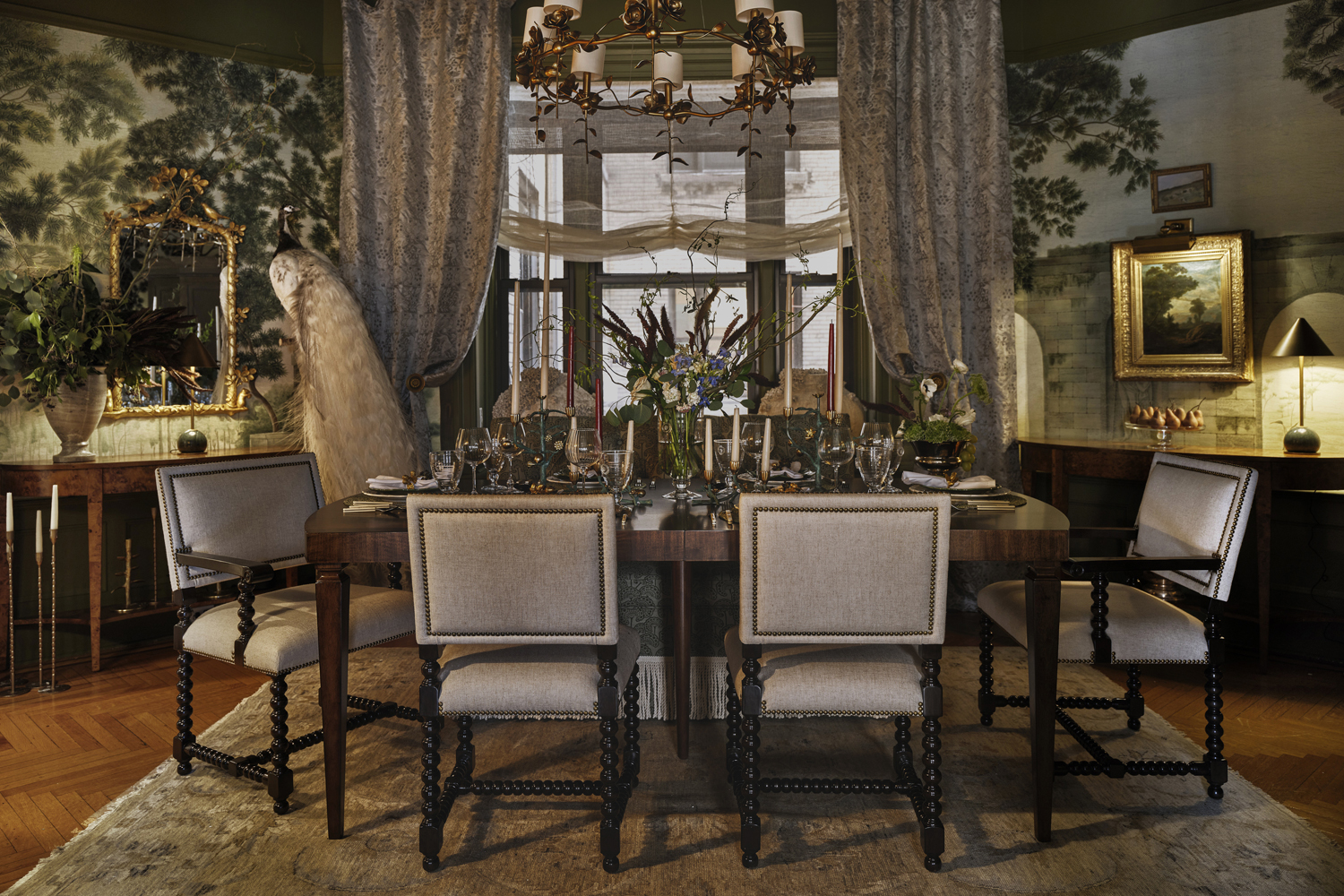 An apartment dining room with an extendable wood dining table, barley twist chairs, and an antique gold chandelier