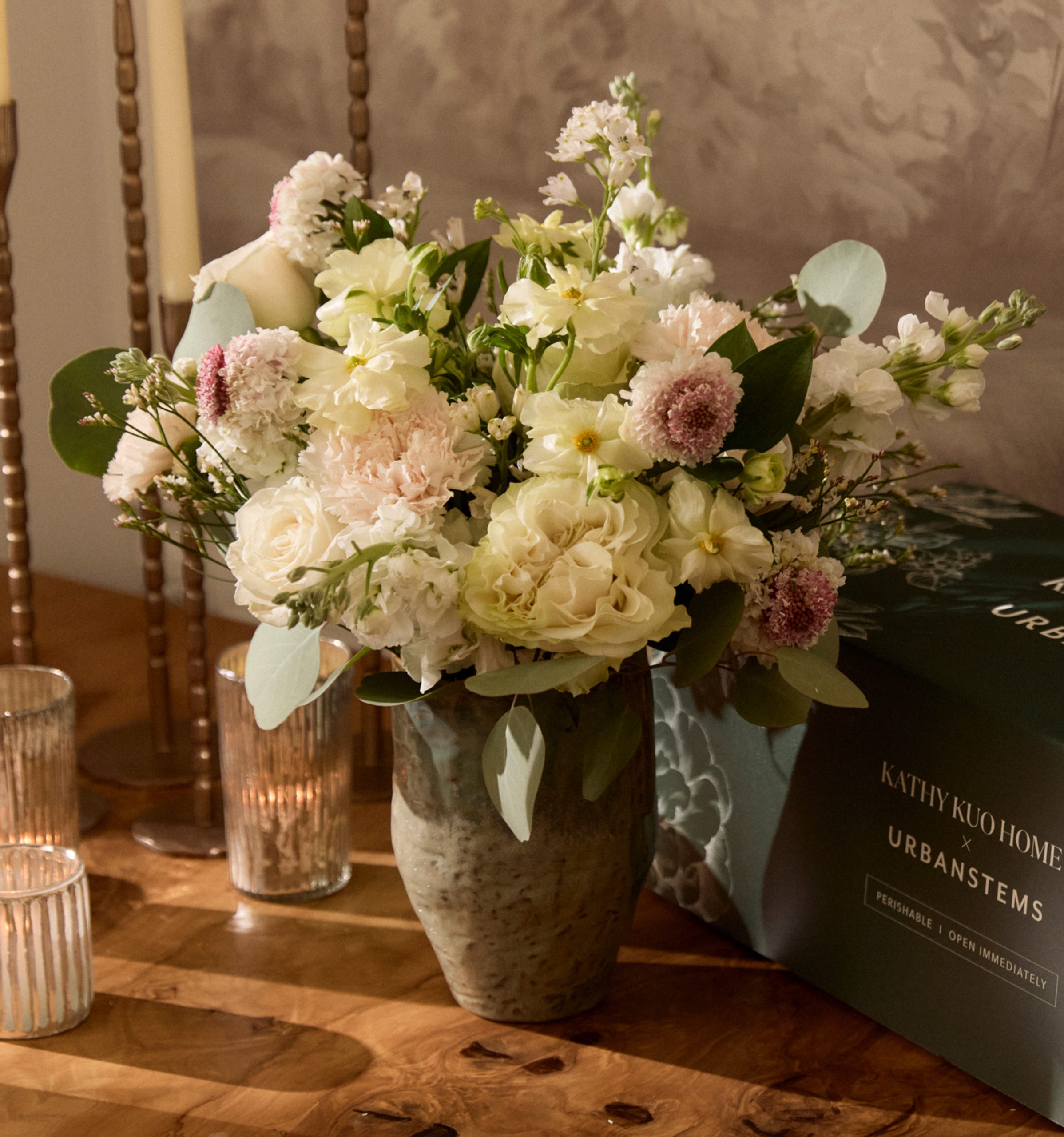 A Kathy Kuo Home x UrbanStems floral bouquet with garden roses, ranunculus, scabiosa, and eucalyptus