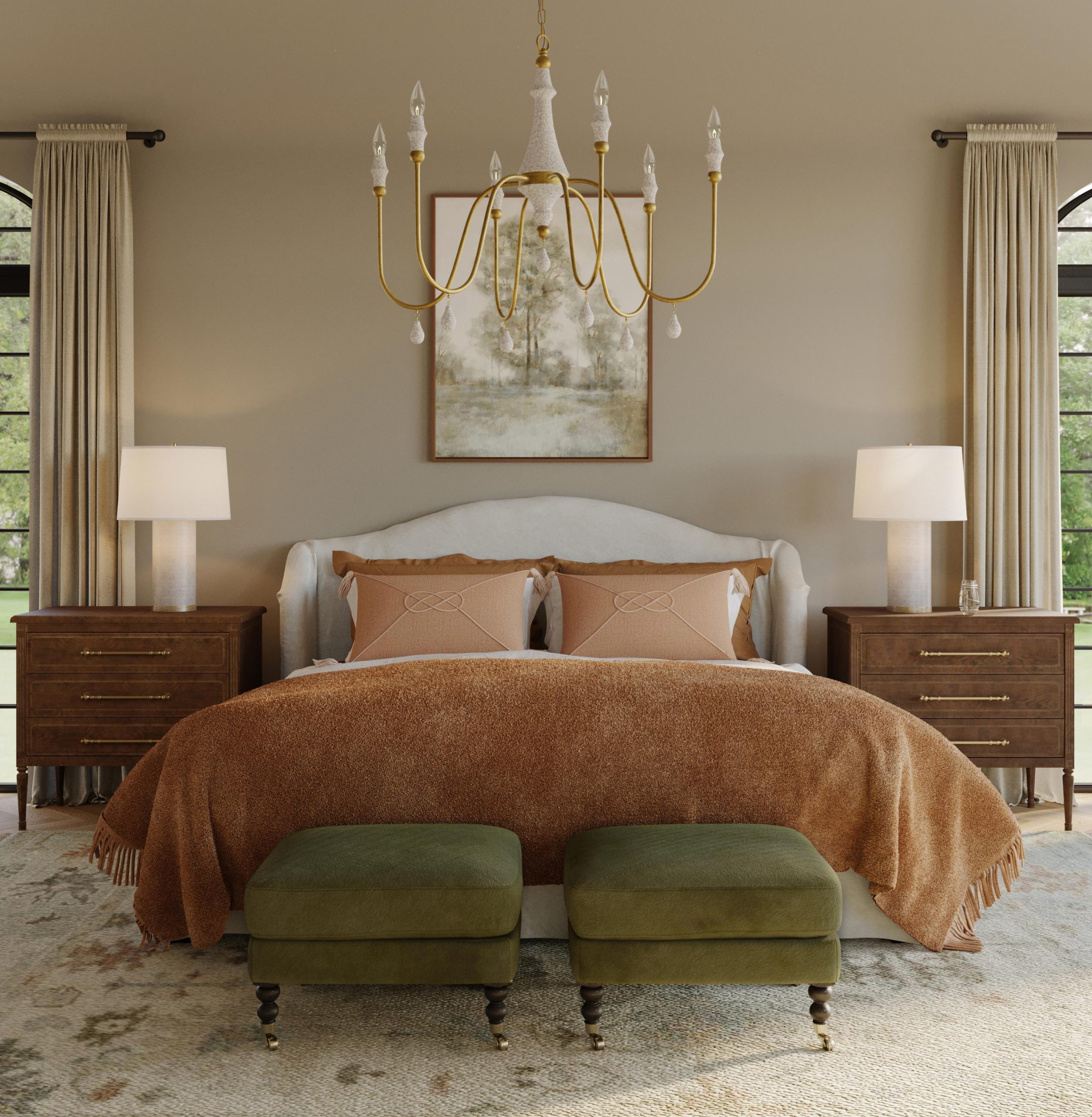 A cozy bedroom with a slipcovered linen wingback bed, alabaster table lamps, three-drawer nightstands, an orange throw blanket, and green Madeline ottomans