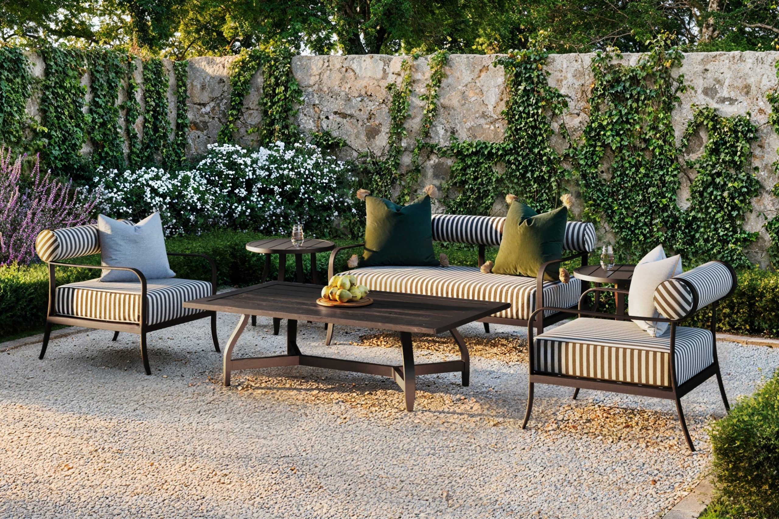 aluminum outdoor furniture with striped sunbrella upholstery sits on a peak gravel outdoor patio