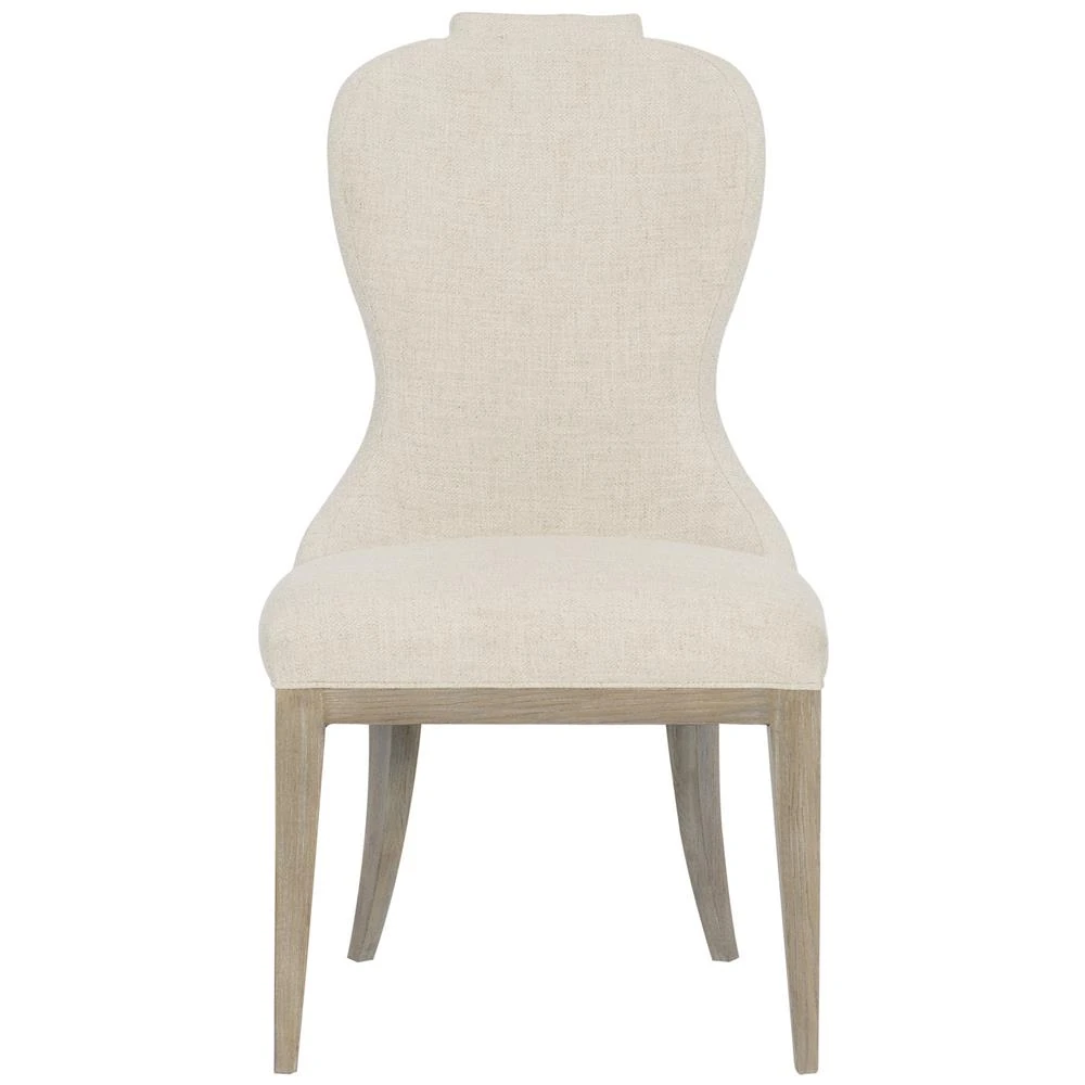 upholstered dining side chair with beige upholstery and light brown wood legs