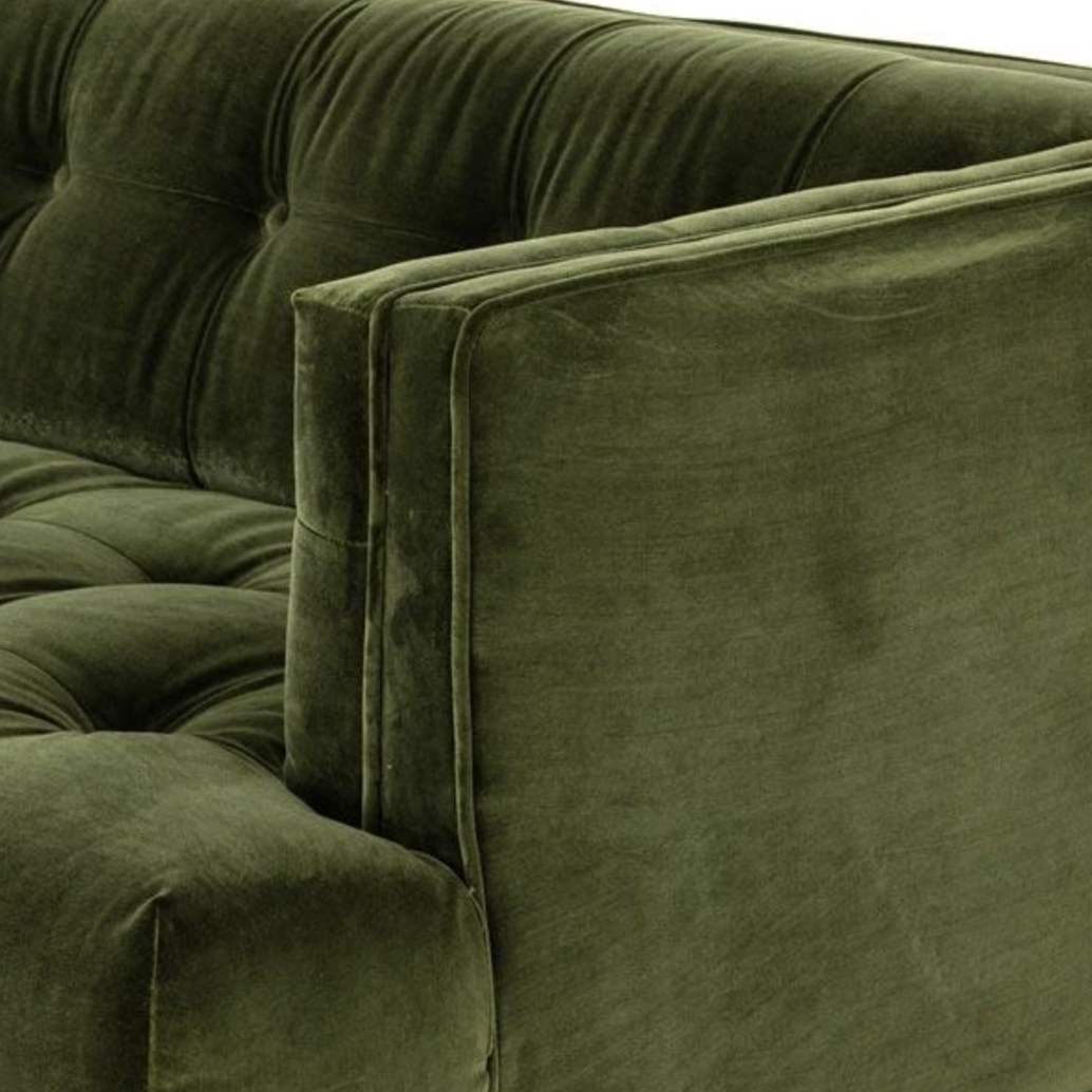 tuxedo arm on green velvet tufted sofa