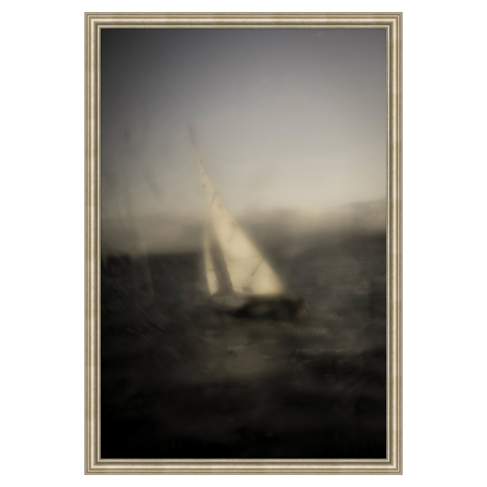 A moody seascape painting with sailboat and a gold frame