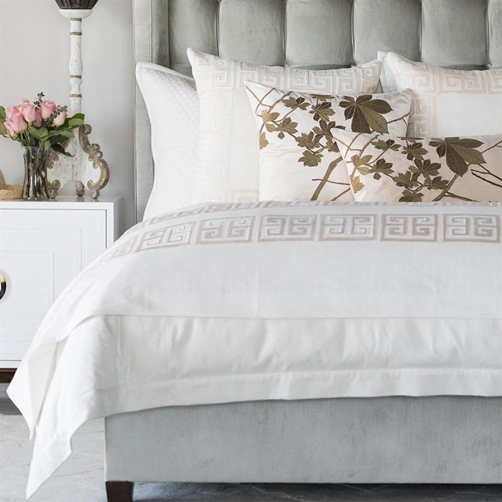 bed with white sheets and decorative pillows