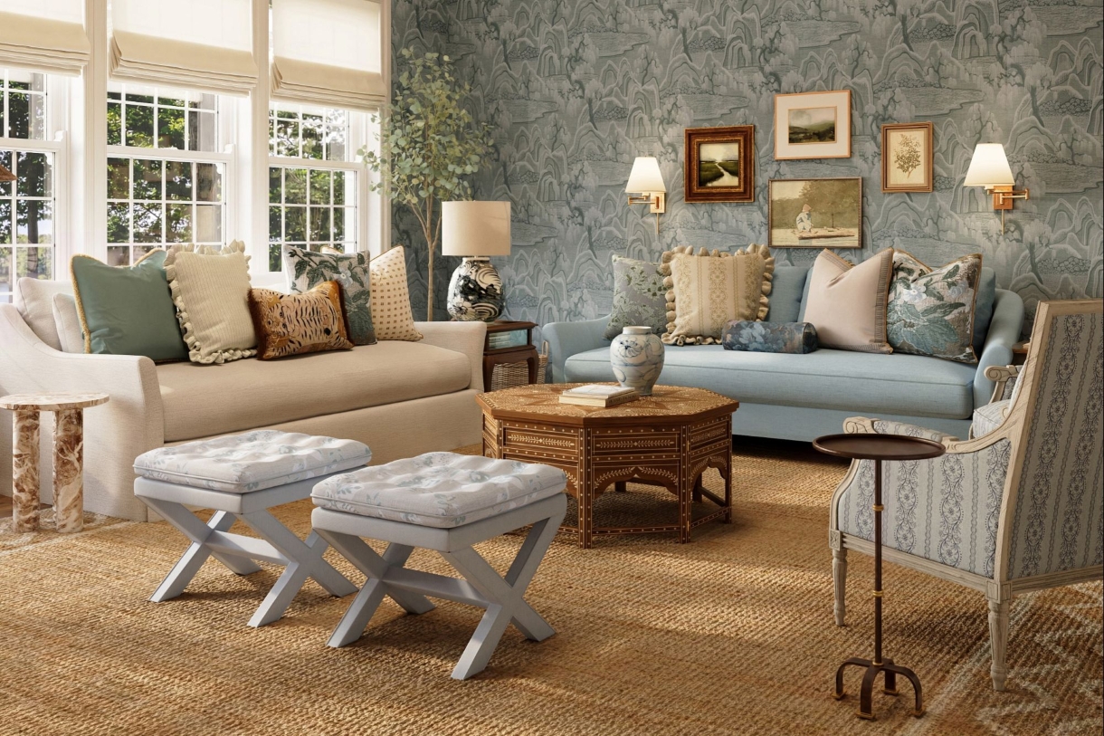 lakeside living room with jute rug, blue roll arm sofa, ivory flare arm sofa, patterned x bench stools, and layered throw pillows