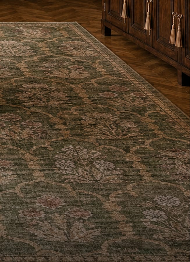 Patterned green rug layered beneath dining furniture
