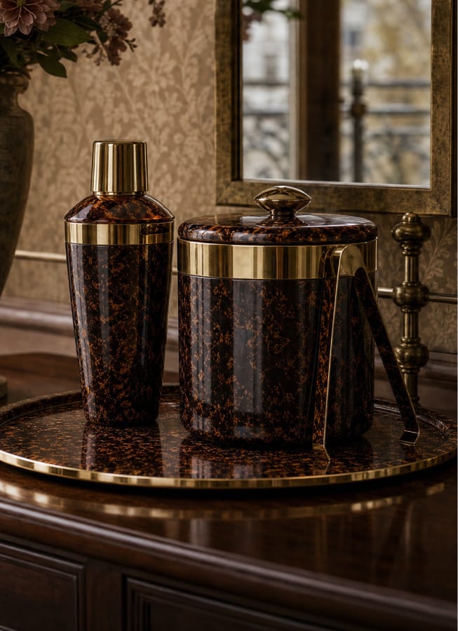 Tortoiseshell barware arranged on a round tray
