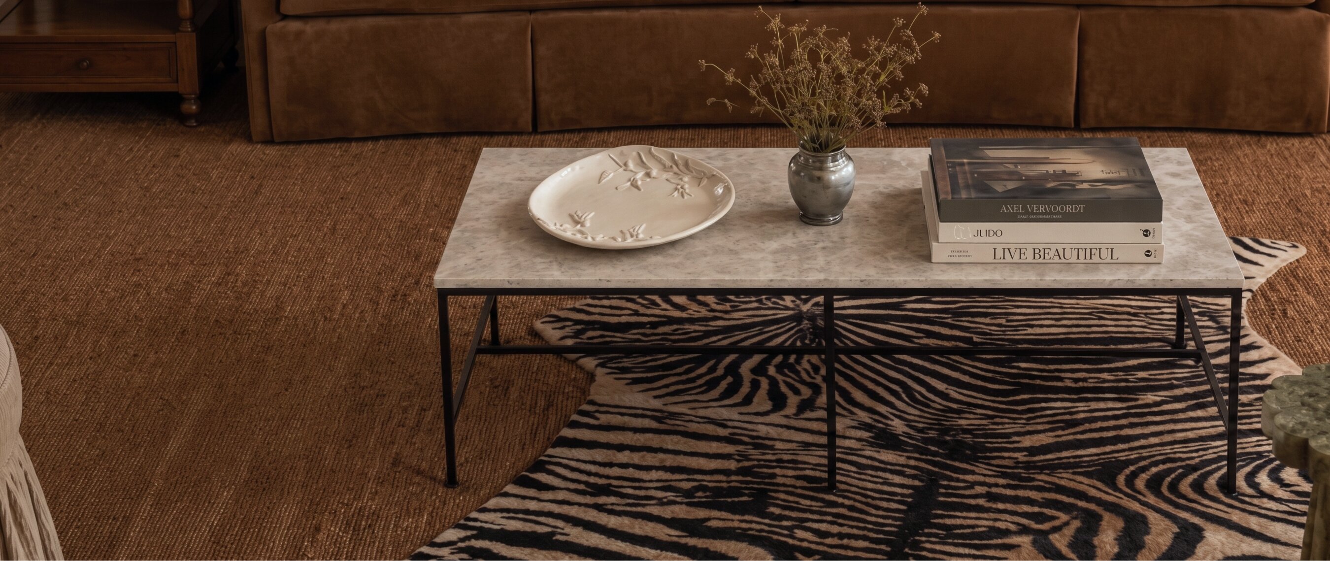 Oversized marble coffee table anchoring a layered seating area