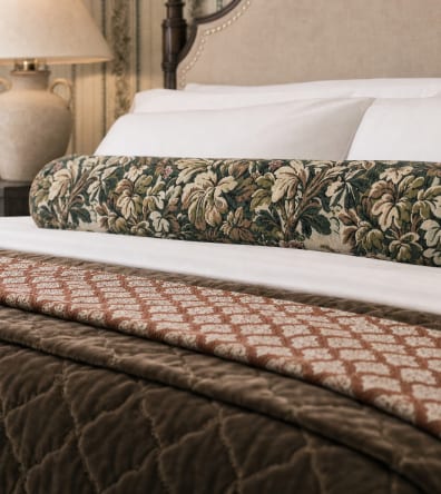 Patterned pillows and throws layered on a bed