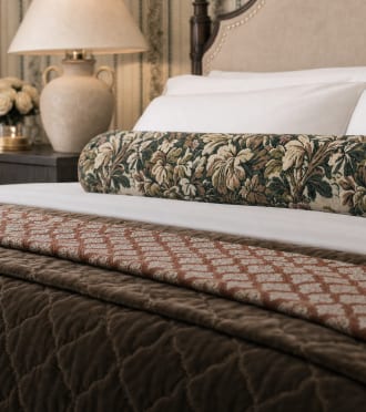 Patterned pillows and throws layered on a bed