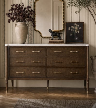Dark wood storage chest styled beneath a mirror