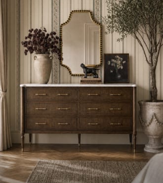 Dark wood storage chest styled beneath a mirror