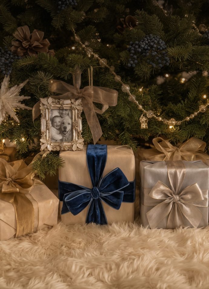 Wrapped gifts with velvet bows beneath a Christmas tree
