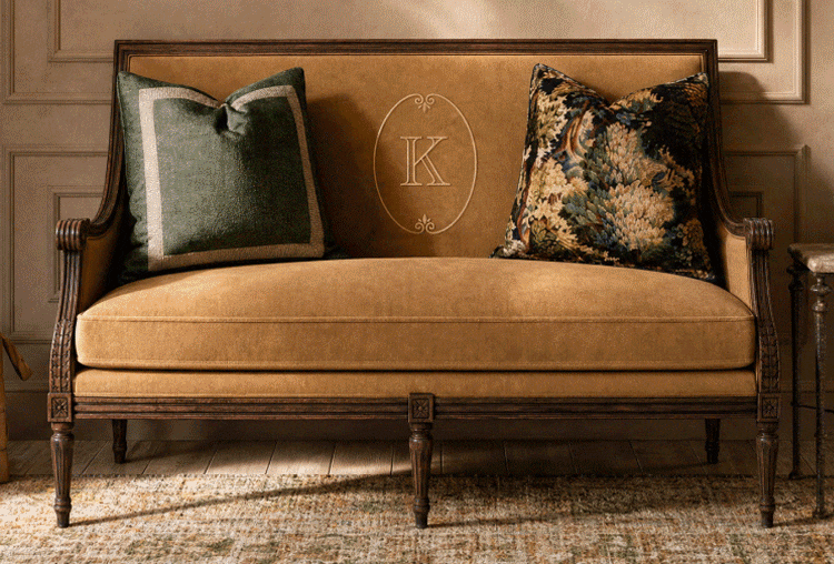 Camel velvet settee with an embroidered monogram and tapestry pillows