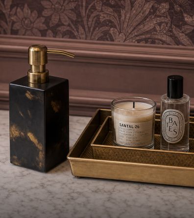 Tortoise soap dispenser and candles on a brass tray