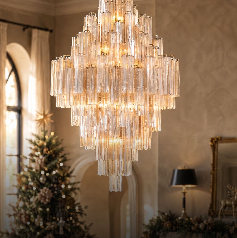Tiered glass-rod chandelier above a Christmas tree