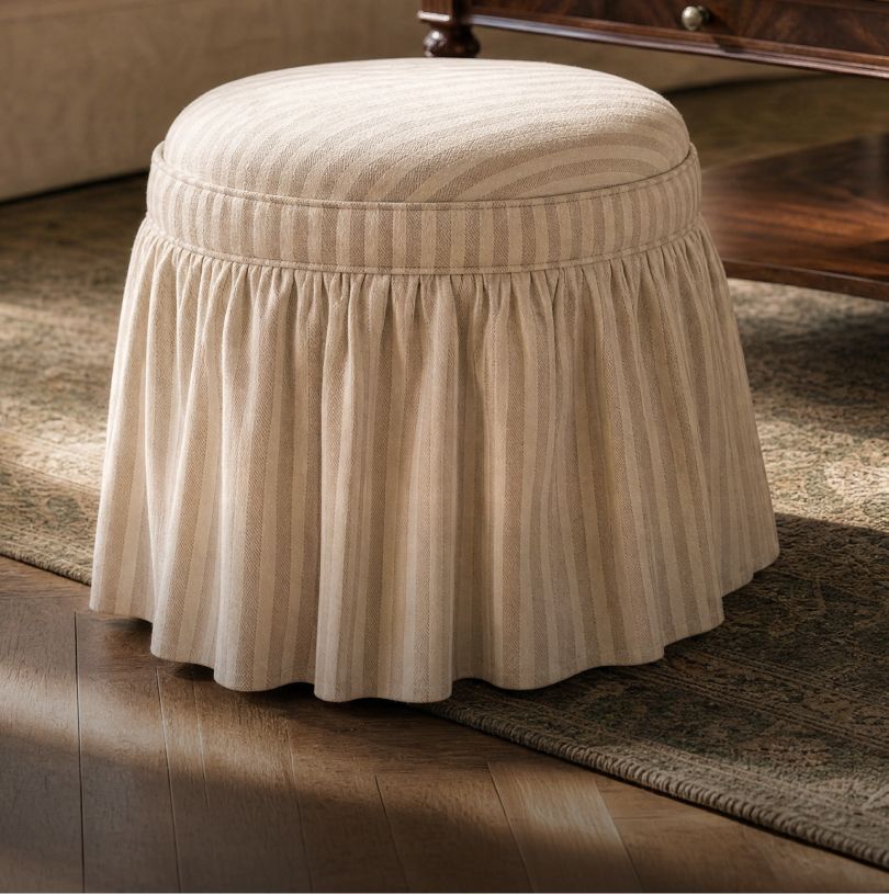 Striped skirted ottoman on a patterned rug