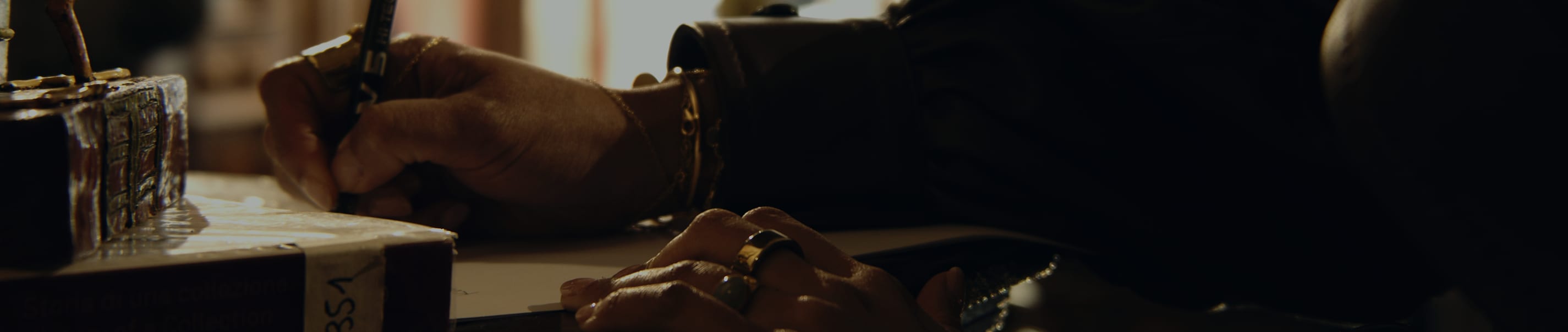 Artisan hand-gilding a carved furniture detail